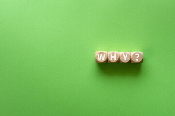 There is wood cube with the word WHY?. It is as an eye-catching image.