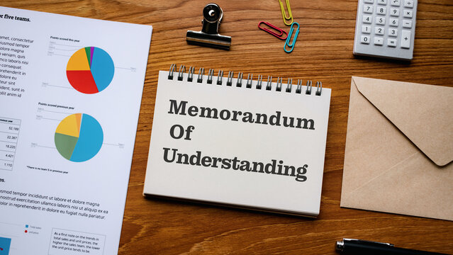 There is notebook with the word MOU. It is as an eye-catching image.