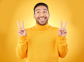 Peace, hands and happy asian man in studio with thank you, vote or feedback on yellow background....