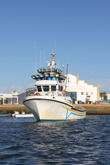 Naklejka premium fishing boat near the harbor waiting to go fishing