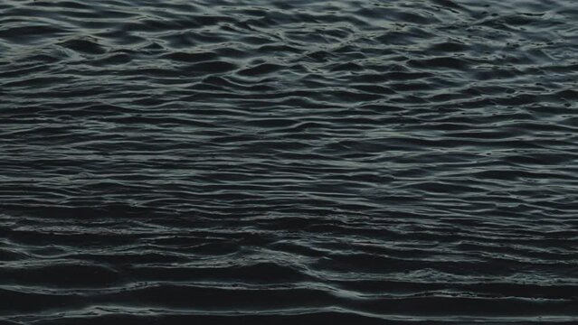 Slow motion waves background, Close up of dark ocean water waves flowing in the sea background