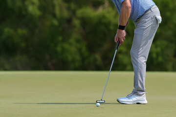 Fototapeta premium professional golf player hitting the ball