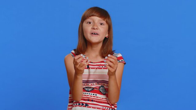 Oh my God, Wow. Young preteen child girl kid looking surprised at camera with big eyes, shocked by sudden victory game winning lottery goal achievemen good news. Children isolated on blue background