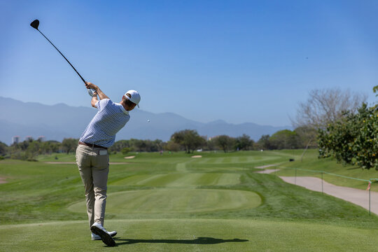 professional golf player hitting the ball. backswing