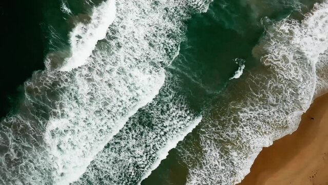 Beautiful sea summer landscape, Waves sea water surface High quality video Bird's eye view, Drone top view waves crashing on sand beach,Nature ocean sea beach background