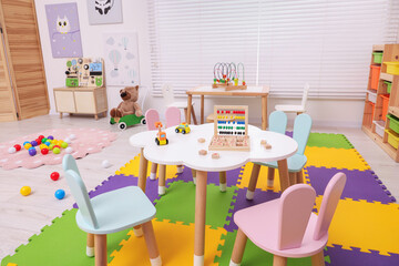 Stylish kindergarten interior with toys and modern furniture