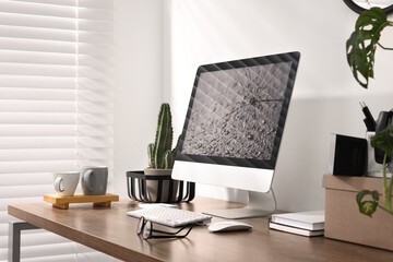 Fototapeta premium Cozy workspace with computer on wooden desk at home