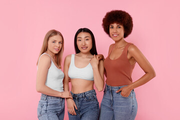 Fototapeta premium Portrait of beautiful young women on pink background