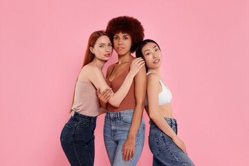 Portrait of beautiful young women on pink background
