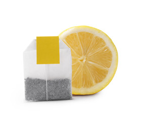 New tea bag with label and half of lemon on white background
