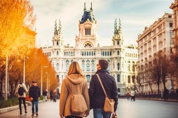 Cercles muraux Madrid Madrid Spain travel destination. Two tourists walking through city front view. Tour tourism exploring.