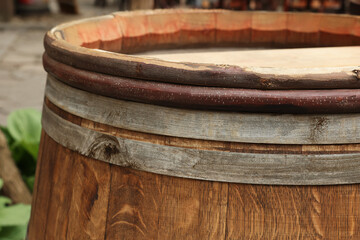 Traditional wooden barrel on street outdoors, closeup. Wine making