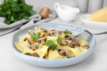 Delicious ravioli with mushrooms served on white table, closeup