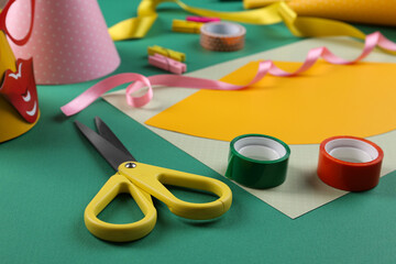 Handmade party hat. Template and tools on green background, closeup