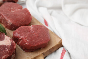 Cut fresh beef meat on wooden board, closeup. Space for text