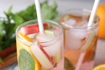 Tasty rhubarb cocktail with orange, closeup. Space for text