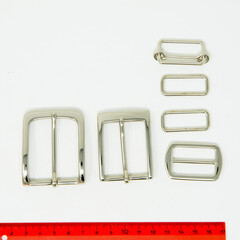 A collection of metal fittings used for leather products