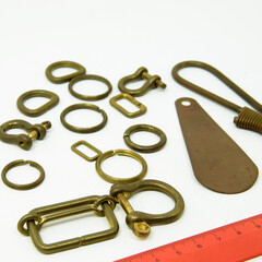 A collection of metal fittings used for leather products