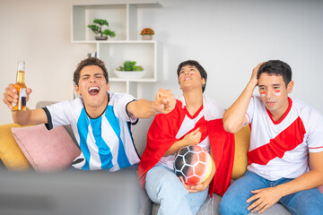 Fototapeta premium Friends from rival teams excitedly watching a soccer game