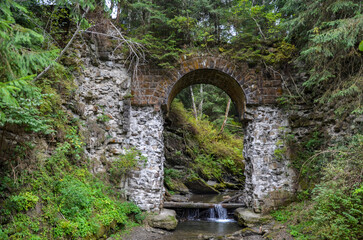 Picturesque ruins of the narrow-gauge viaduct carriage bridge in the village of Vorokhta, Carpathian Mountains, Ukraine