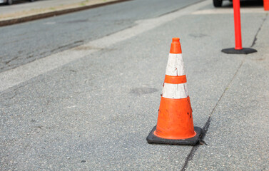 Vibrant construction cone amidst urban chaos signifies progress, safety, roadwork, caution, and...