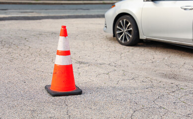Vibrant construction cone amidst urban chaos signifies progress, safety, roadwork, caution, and...