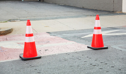 Vibrant construction cone amidst urban chaos signifies progress, safety, roadwork, caution, and...