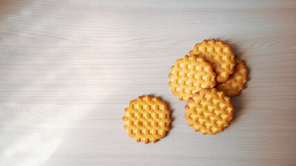 Freshly baked round cookies. On a wooden background. Minimal concept, diagonal space for copying.