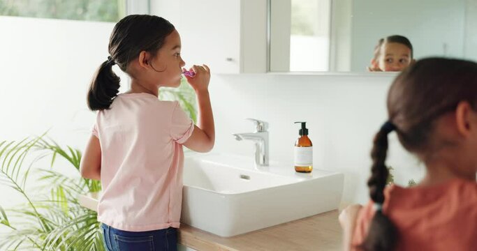 Siblings, home or children in bathroom brushing teeth together in daily morning or grooming routine. Kids, oral care or girls cleaning teeth together with toothbrush or toothpaste for dental health
