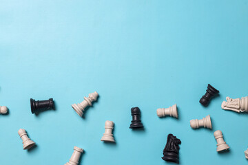 Fototapeta premium Top view of chess figures on blue background with free copy space for your text. Business strategy, decision and teamwork concept