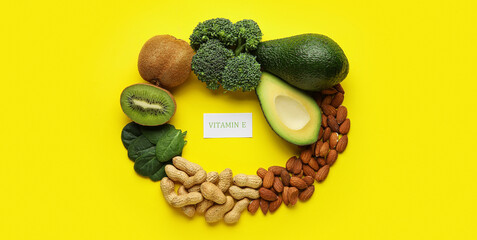 Frame made of healthy products rich in vitamin E on yellow background
