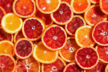 Many slices of juicy blood orange fruits as background