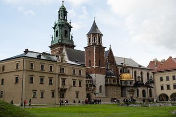 Fototapeta na wymiar Summer view of Wawel Royal Castle in Krakow, Poland. Historically and culturally important site in Poland. Flowers on foreground. Beautiful sightseeing with Wawel Royal Castle and colorful flowers in
