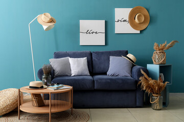Interior of cozy living room with blue sofa and coffee table