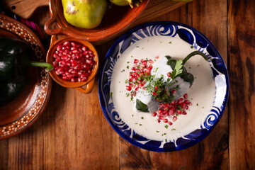 Chiles en Nogada, Typical dish from Mexico. Prepared with poblano chili stuffed with meat and...