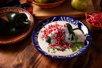 Chiles en Nogada, Typical dish from Mexico. Prepared with poblano chili stuffed with meat and fruits and covered with a walnut sauce. Named as the quintessential Mexican dish for national holidays.