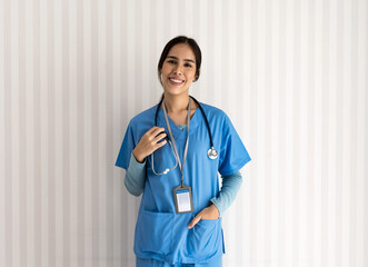 Smiling young Asian doctor woman in uniform standing , Senior home care
