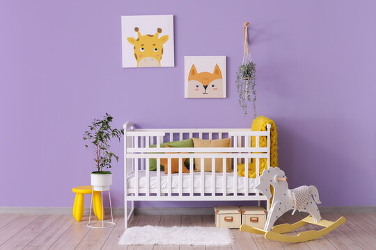 Stylish interior of children's room with baby bed and rocking horse