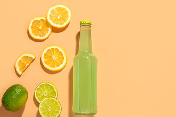 Composition with bottle of fresh soda and lime on beige background
