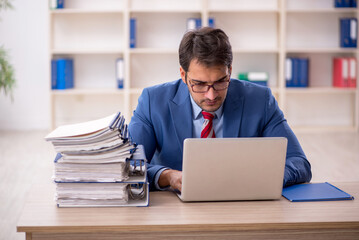 Young male employee working in the office