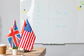 Different flags on table in English classroom, closeup - obrazy, fototapety, plakaty