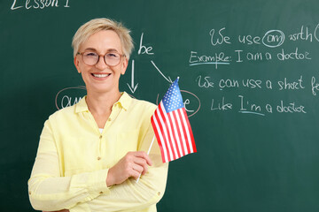 Female English teacher with USA flag in classroom