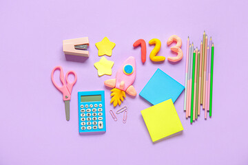 Rocket and numbers made of plasticine with stationery on lilac background - obrazy, fototapety, plakaty