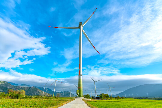 Panoramic View Of Wind Farm Or Wind Park. Green Meadow With Wind Turbines Generating Electricity. Green Energy Concept.