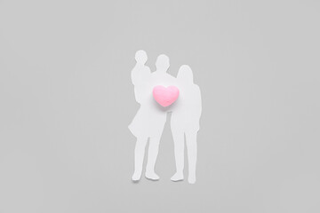 Figures of family with heart on grey background. Family love concept