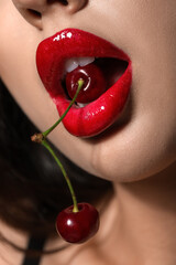 Beautiful woman with red lips and cherries, closeup