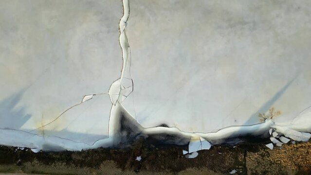 Drone view of top icecerg in a lake. The craking of iceberg across the lake. 