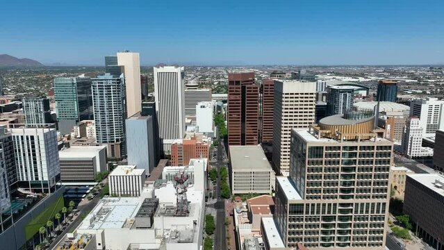 Downtown Phoenix, Arizona skyscrapers. Aerial reverse dolly shot in inner city. Establishing drone video of beautiful cityscape.