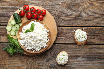 Cottage cheese, cucumber, tomatoes, sandwiches and basil on wooden table