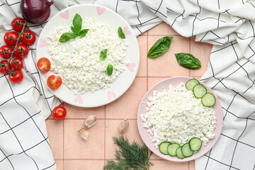 Plates with cottage cheese and vegetables on tiled table